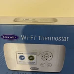 This Carrier Wi-fi Thermostat (model TC-WHS01). Used Good Condition. Price: $100.00.